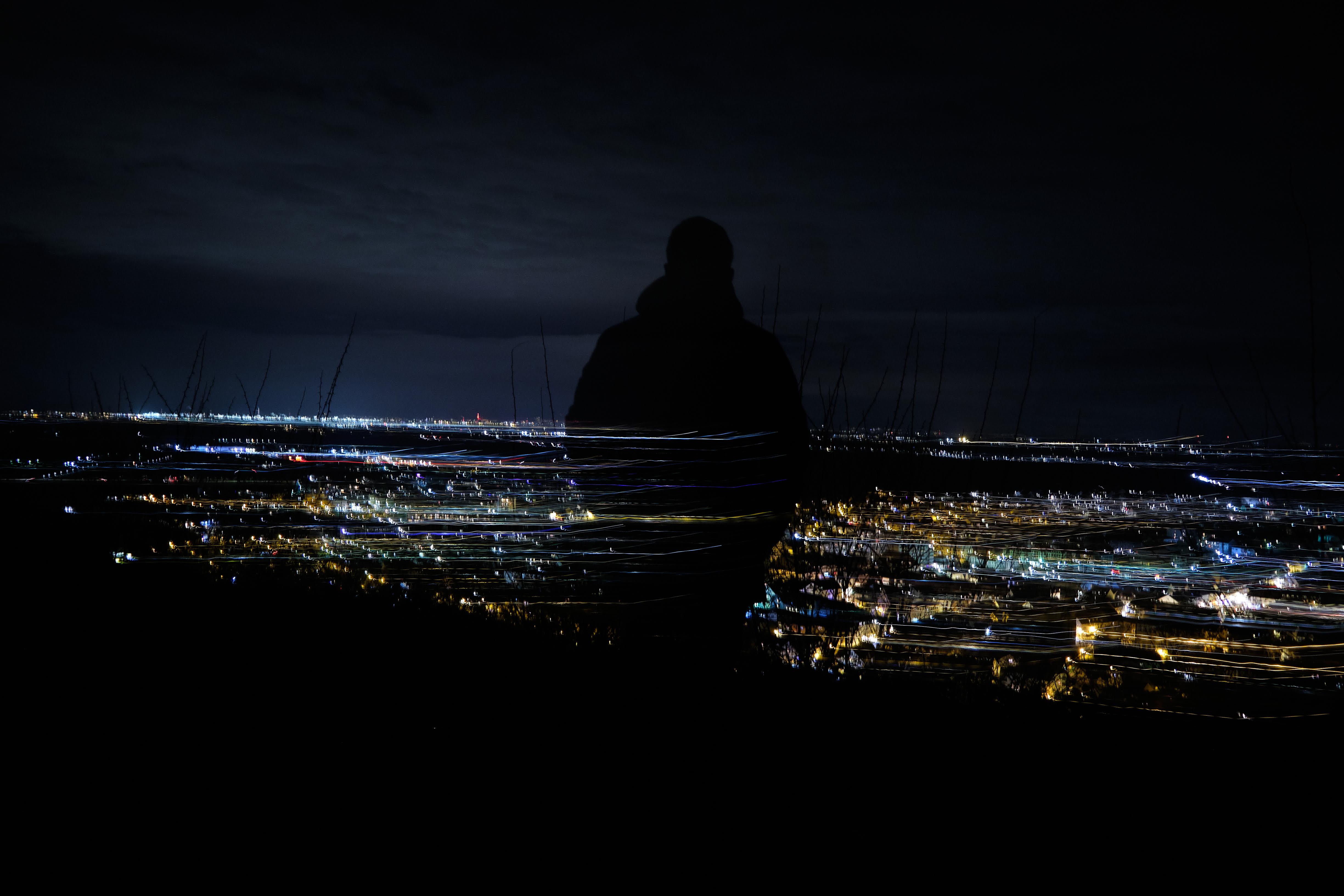 CryBoy watching over a skyline in the night